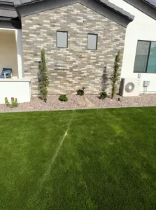 Window reflection creating concentrated sunlight on artificial turf near a home